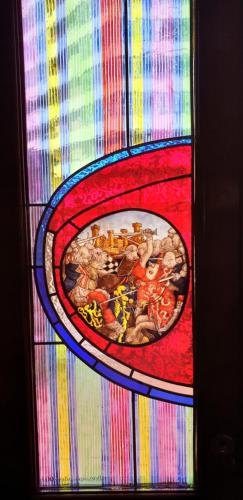 a stained glass window of a painting on a table at Hotel Castillo de Gauzón in Salinas