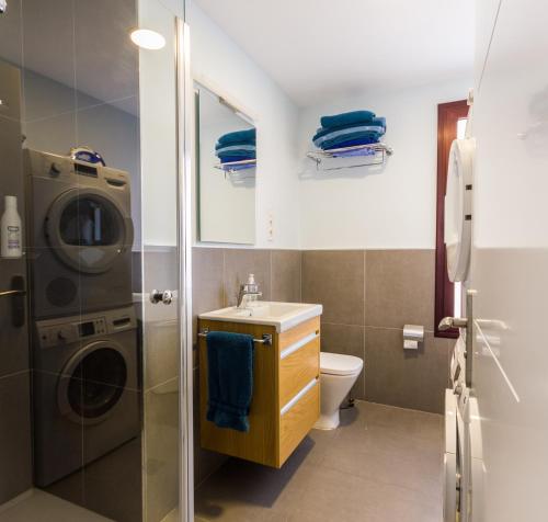 ein Badezimmer mit Waschbecken und Waschmaschine in der Unterkunft Canteras Luxury Beach Apartments in Las Palmas de Gran Canaria