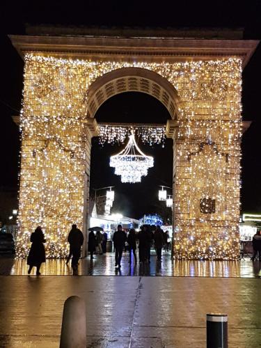 a large arch with christmas lights at night at H&ocirc;tel Montchapet Dijon Centre in Dijon