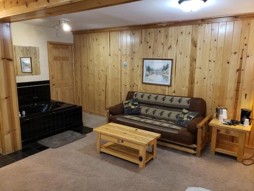 a living room with a couch and a tub at Willard Munger Inn in Duluth