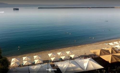 an aerial view of a beach with umbrellas at Hotel Ostria in Kalamata