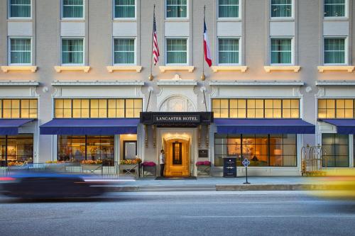 a large building with a clock on the front of it at The Lancaster Hotel in Houston