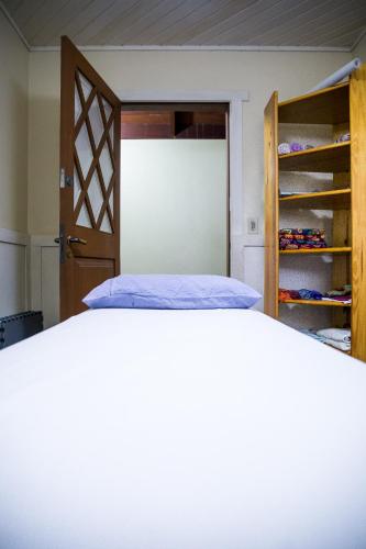 a bedroom with a bed and a closet at OM B&B + Spa in Viamão