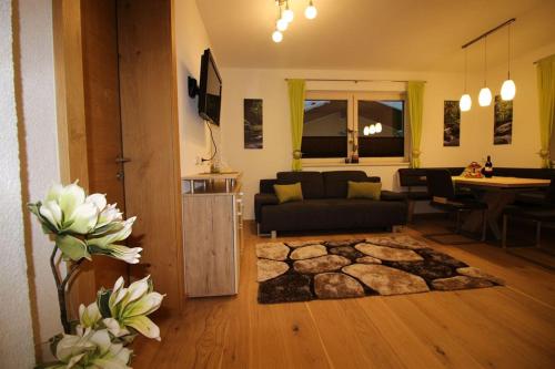 a living room with a couch and a rug at Apart Melanie in Zell am Ziller