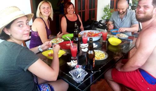 a group of people sitting around a table eating food at Golden Town Hotel in Tangalle