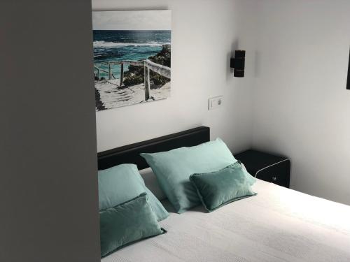 a bedroom with a bed with two pillows at Suites D'Elice in El Palmar