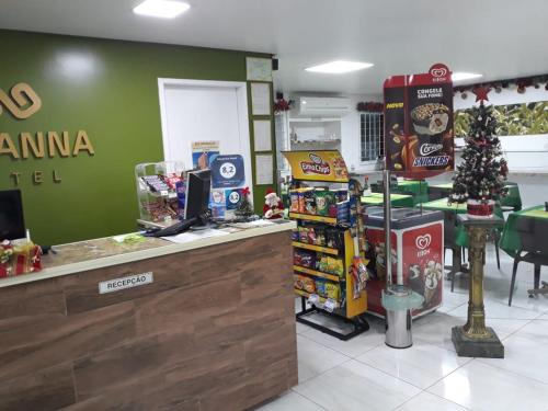 a grocery store with a christmas tree and a counter at Goyanna Hotel in Goiana