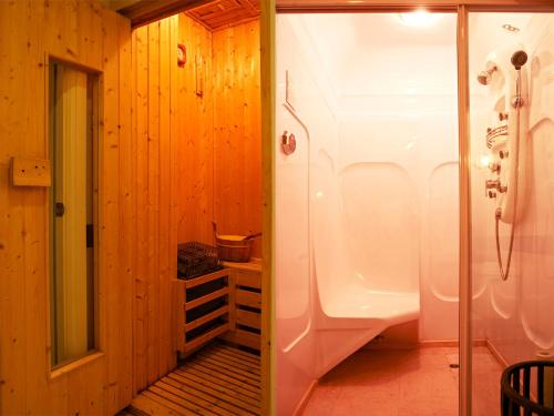 a bathroom with a shower and a sink in a room at Grand Noble Hotel Dongguan in Dongguan