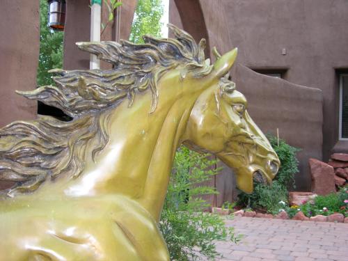 a gold horse statue in front of a building at Adobe Grand Villas in Sedona