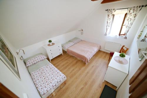 a small bedroom with two beds and a table at Restaurace a pension Chalupa in Vorder Třebau