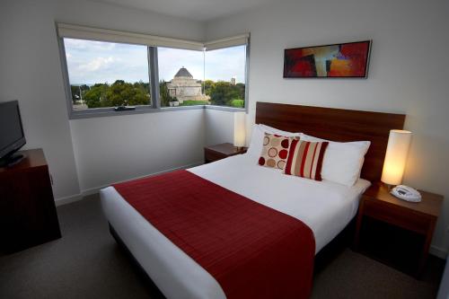 a hotel room with a bed and a window at Quest on Dorcas in Melbourne