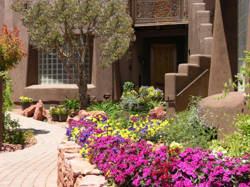 a garden of flowers in front of a building at Adobe Grand Villas in Sedona
