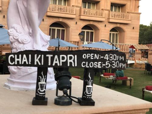 a camera with a sign in front of a building at Evershine Resort & Spa in Mahabaleshwar