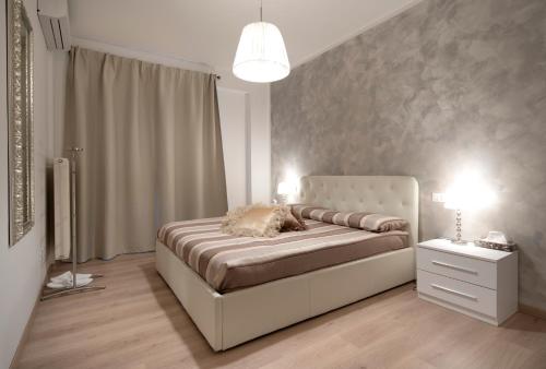 a bedroom with a large bed and a lamp at Nice & Cozy apartment in Venice