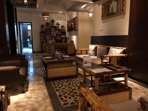 a living room with couches and tables in a store at Evershine Resort & Spa in Mahabaleshwar