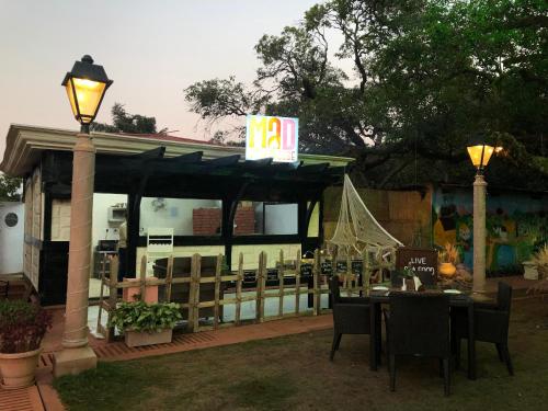 a restaurant with a table and chairs and a sign at Evershine Resort & Spa in Mahabaleshwar