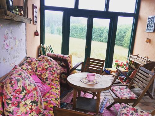 a living room with a couch and a table at Pod tulipanem nad jeziorem in Zawady Oleckie