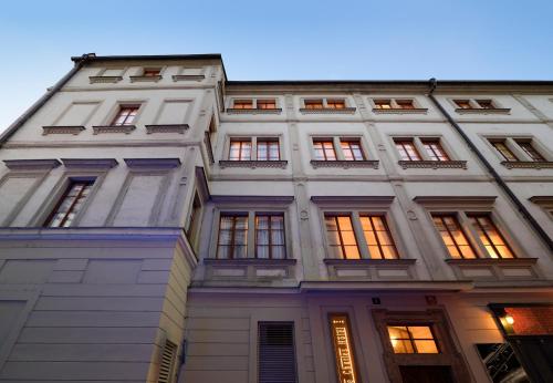 a tall white building with many windows at The Charles in Prague