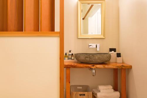 a bathroom with a sink and a mirror at Hosking House in New Plymouth