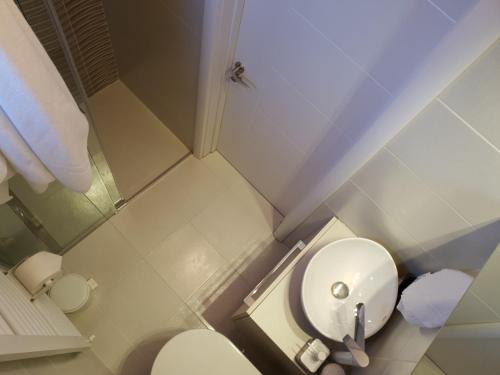 a small bathroom with a white toilet in it at Apartment New Belgrade Home in Belgrade