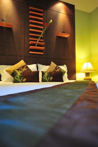 a bedroom with a bed and a vase of flowers at Hua Hin White Sand in Hua Hin
