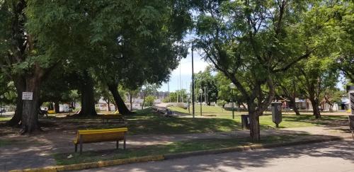 a park with a bench in a park with trees at Hotel Hostal Caballito Blanco in Santa Fe