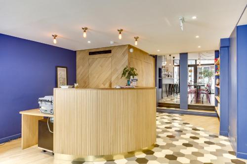 a kitchen with blue walls and a counter top at Kyriad Paris 12 - Nation in Paris