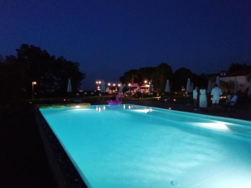 a large swimming pool at night with lights at Agriturismo La Rinaldina in Faenza