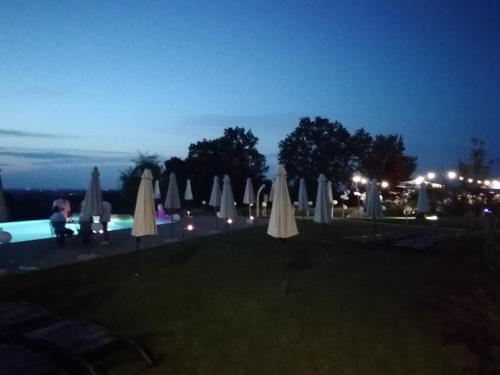 a group of umbrellas and a pool at night at Agriturismo La Rinaldina in Faenza