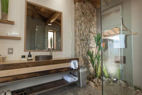 a bathroom with a sink and a mirror at Vista del Alma Boutique - Adult Only in Santa Teresa Beach
