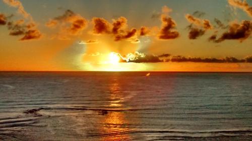 a sunset over the ocean with the word change written in clouds at Casa Vila Do Outeiro in Praia do Espelho