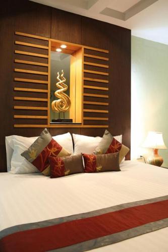 a bedroom with a large bed with white pillows at Hua Hin White Sand in Hua Hin