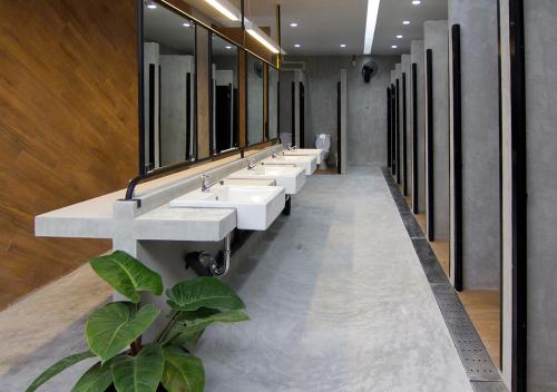 a bathroom with a row of sinks and mirrors at TAN Hostel x Cafe , Aonang Beach in Ao Nang Beach