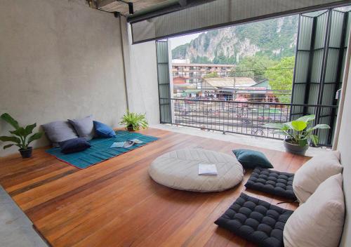 a living room with a view of a mountain at TAN Hostel x Cafe , Aonang Beach in Ao Nang Beach