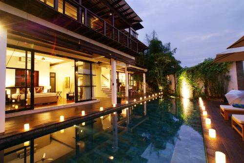 a swimming pool in a house with candles in it at Temple Hill Residence Villa in Jimbaran