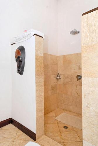 a bathroom with a shower with a toilet and a shower at Agung Bali Nirwana Villas and Spa in Tejakula