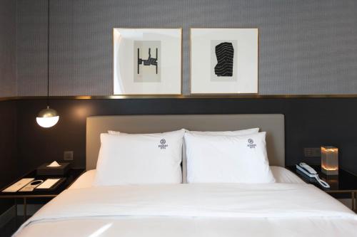 a bedroom with a bed with two white pillows at Browndot Business Seomyeon in Busan