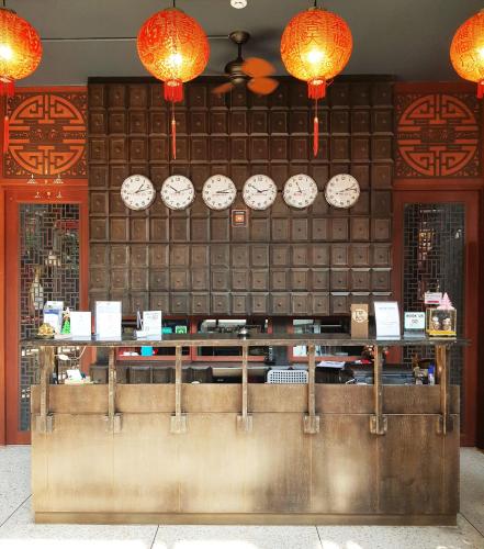 a counter with clocks on the wall in a restaurant at CLOUD on Saladaeng Silom Hostel Bangkok in Bangkok