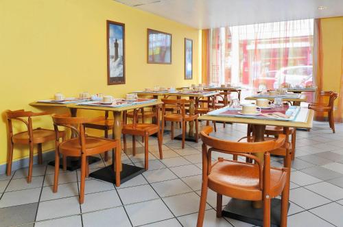 - une salle à manger avec des tables et des chaises dans l'établissement Séjours & Affaires Lyon Saxe-Gambetta, à Lyon