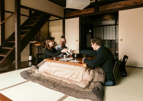 a group of people sitting around a table at Inari Ohan in Kyoto