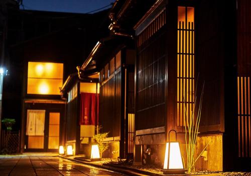 a building with lights on the side of it at night at Inari Ohan in Kyoto
