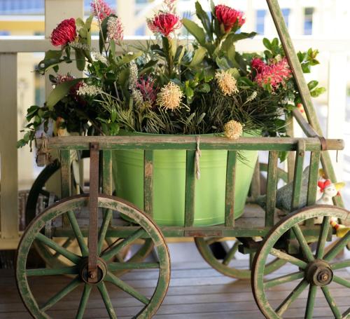 a cart full of flowers on a table at The Spotted Chook and Amelie's Petite Maison in Montville