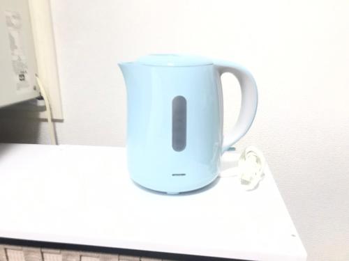 a white coffee cup sitting on a counter at Luxes Hiroshima2030 ラクセス ヒロシマ2030 in Hiroshima