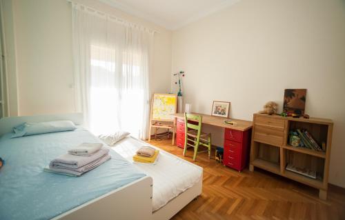 a bedroom with a bed and a desk and a table at 2 BEDROOM APARTMENT AT THE HISTORICAL CENTER, VIEW TO ACROPOLIS in Athens