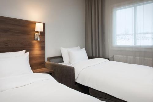 a hotel room with two beds and a window at Park Inn by Radisson Oslo Airport Hotel West in Gardermoen