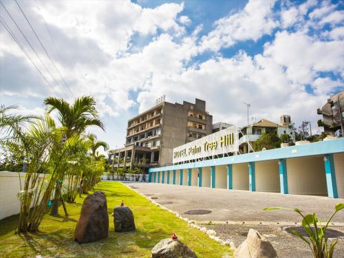 a view of the front of the main building of the resort at Hotel Palm Tree Hill in Okinawa City