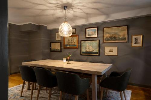 a dining room table with a picture on the wall at Victory Apartments in Stockholm