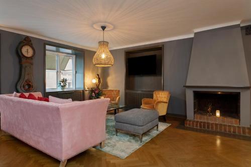 a living room filled with furniture and a fire place at Victory Apartments in Stockholm