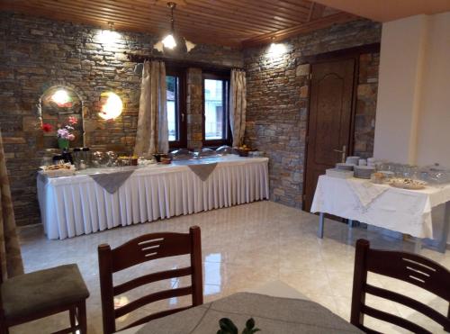 a dining room with two tables and a buffet at Evridiki in Zagora