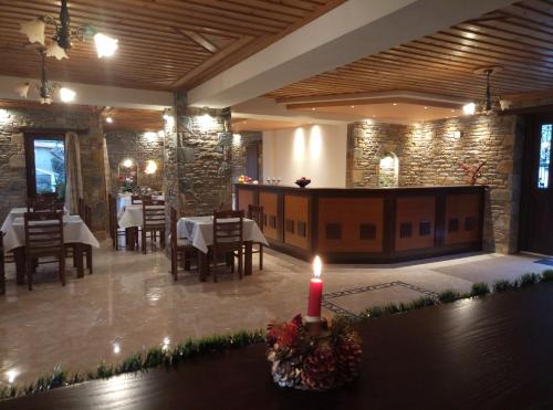 a dining room with a candle on a table at Evridiki in Zagora